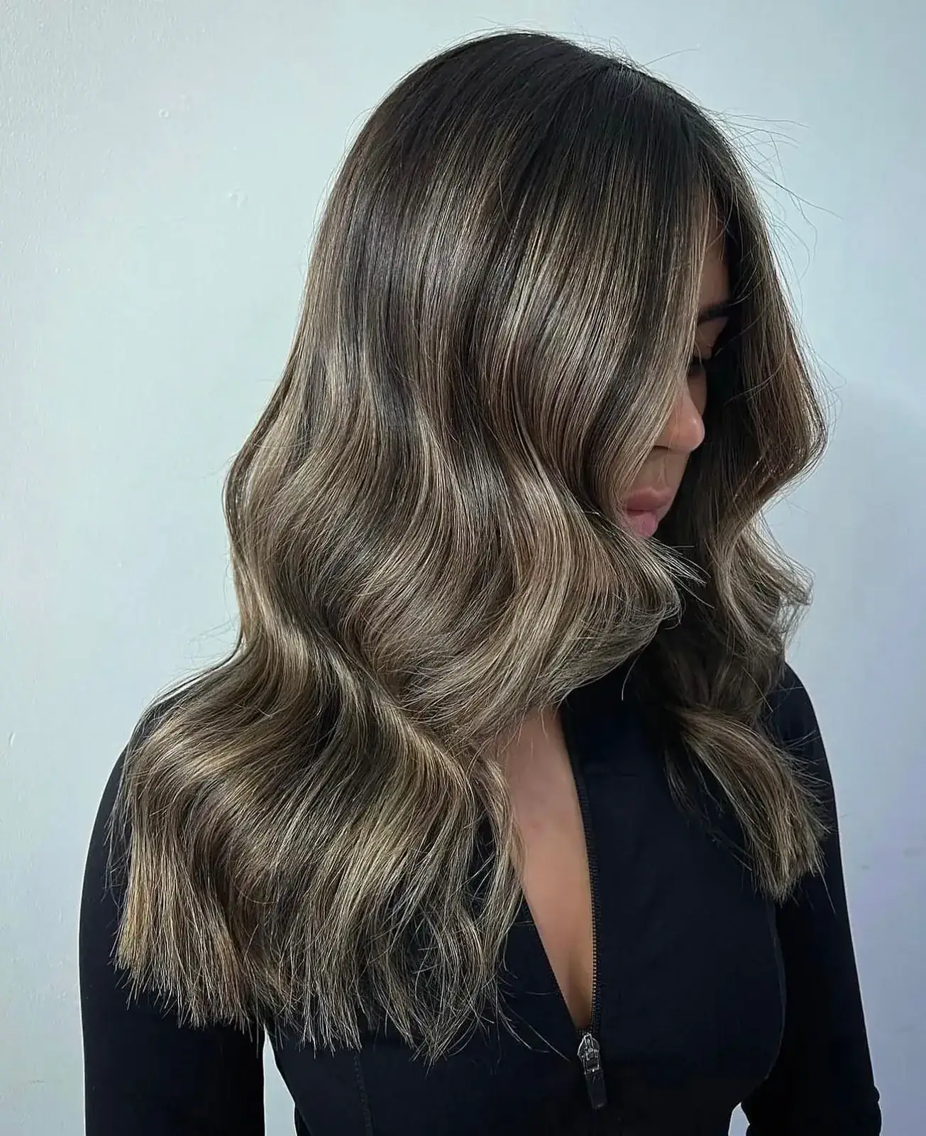 Brunette balayage with hand-painted highlights and soft waves