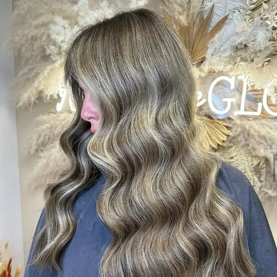 Brunette nano-bond extensions styled into long glossy waves