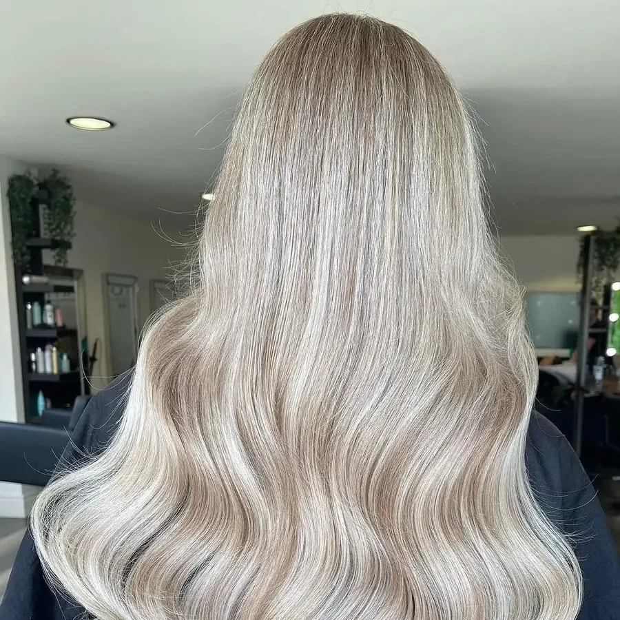 Long blonde tape extensions, glossy and waved